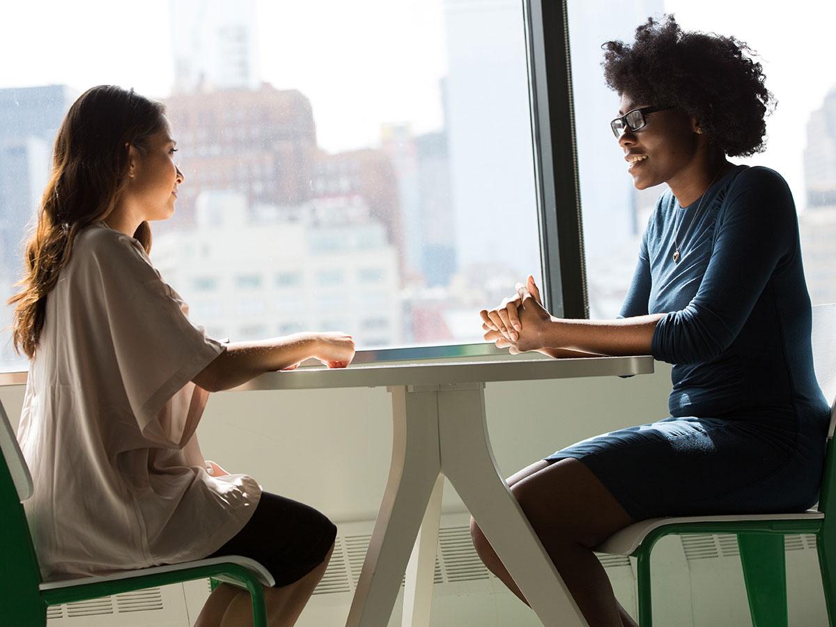 Student sitting at table with interviewer